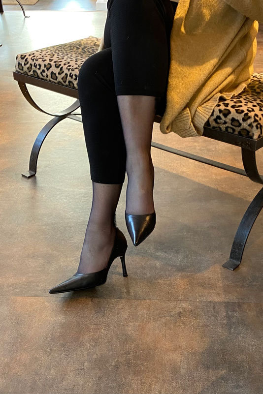 Satin black women's open arch dress pumps. Pointed toe. Very high slim heel. Worn view - Florence KOOIJMAN